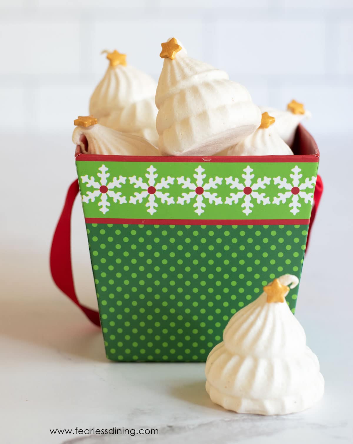 A gift box of meringues shaped like Christmas trees.
