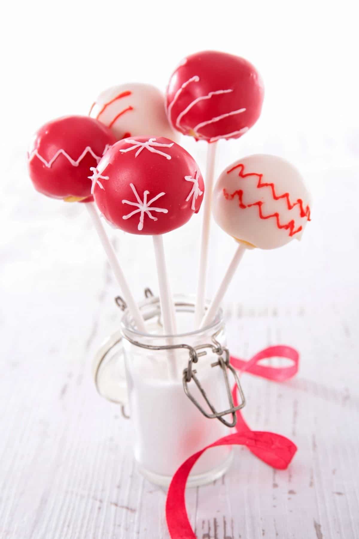 Red and white decorated cake pops.