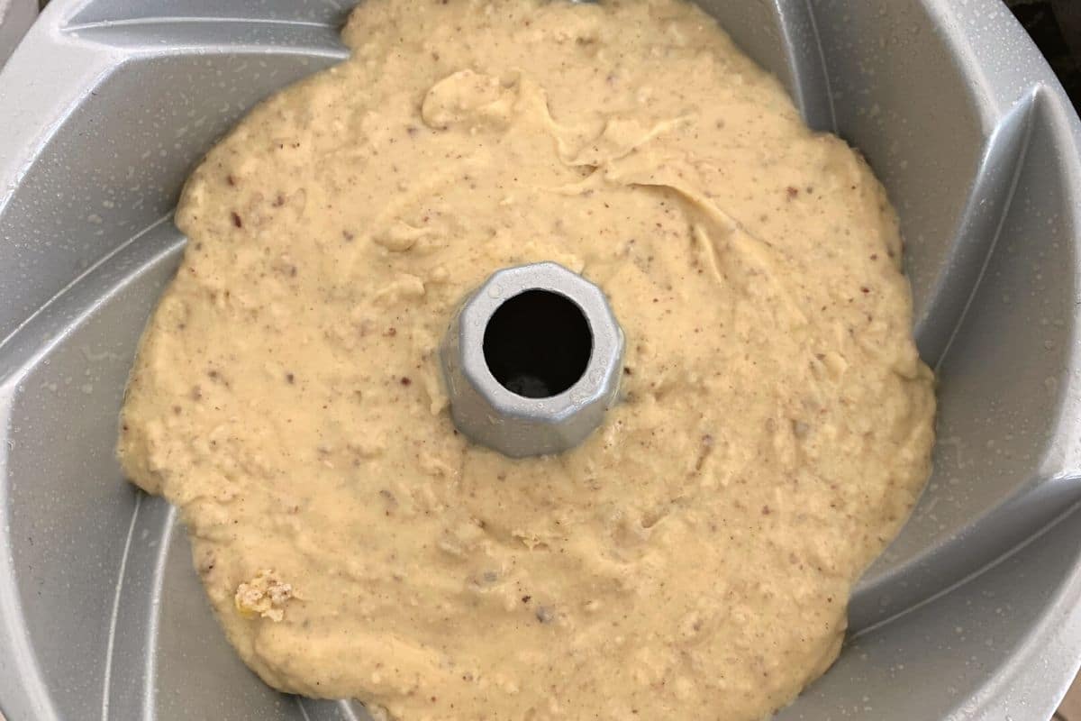 a photo of the gluten free cake batter in the greased bundt pan