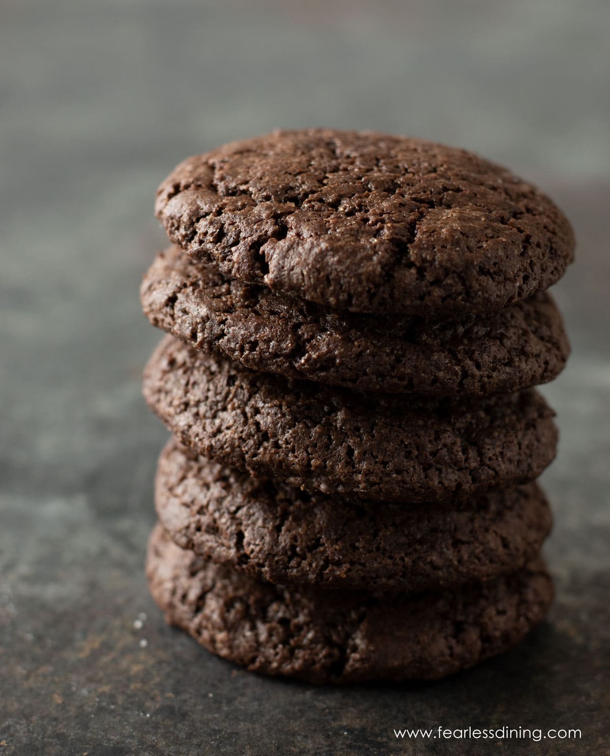 A stack of 5 fudgy gluten free chocolate cookies.
