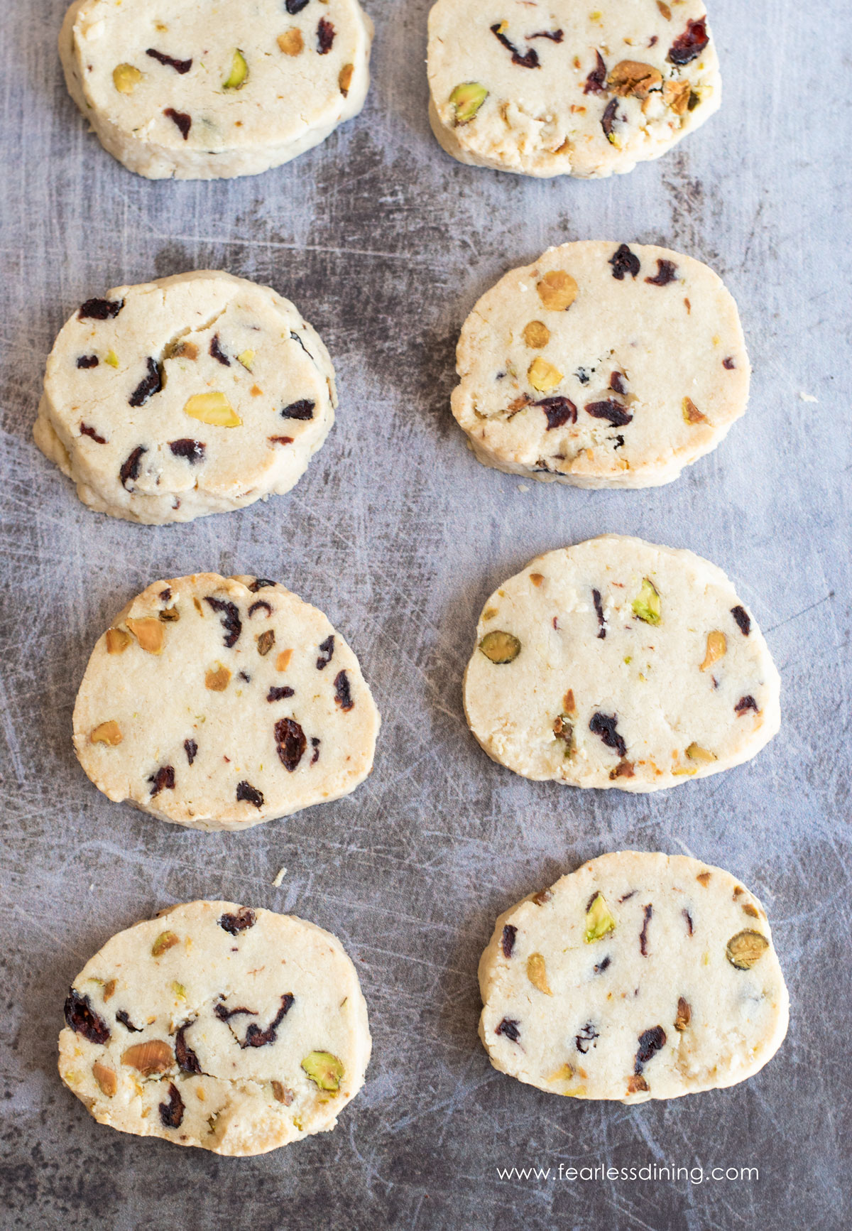 Baked cranberry shortbread cookies on a baking sheet.