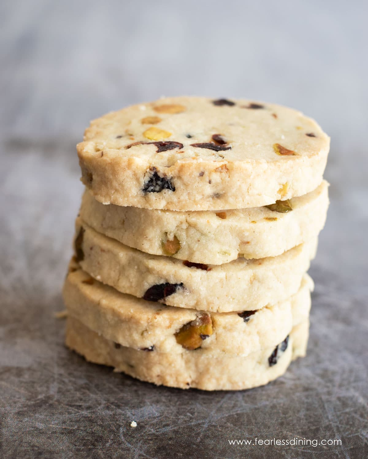 A stack of four gluten free cranberry shortbread cookies.