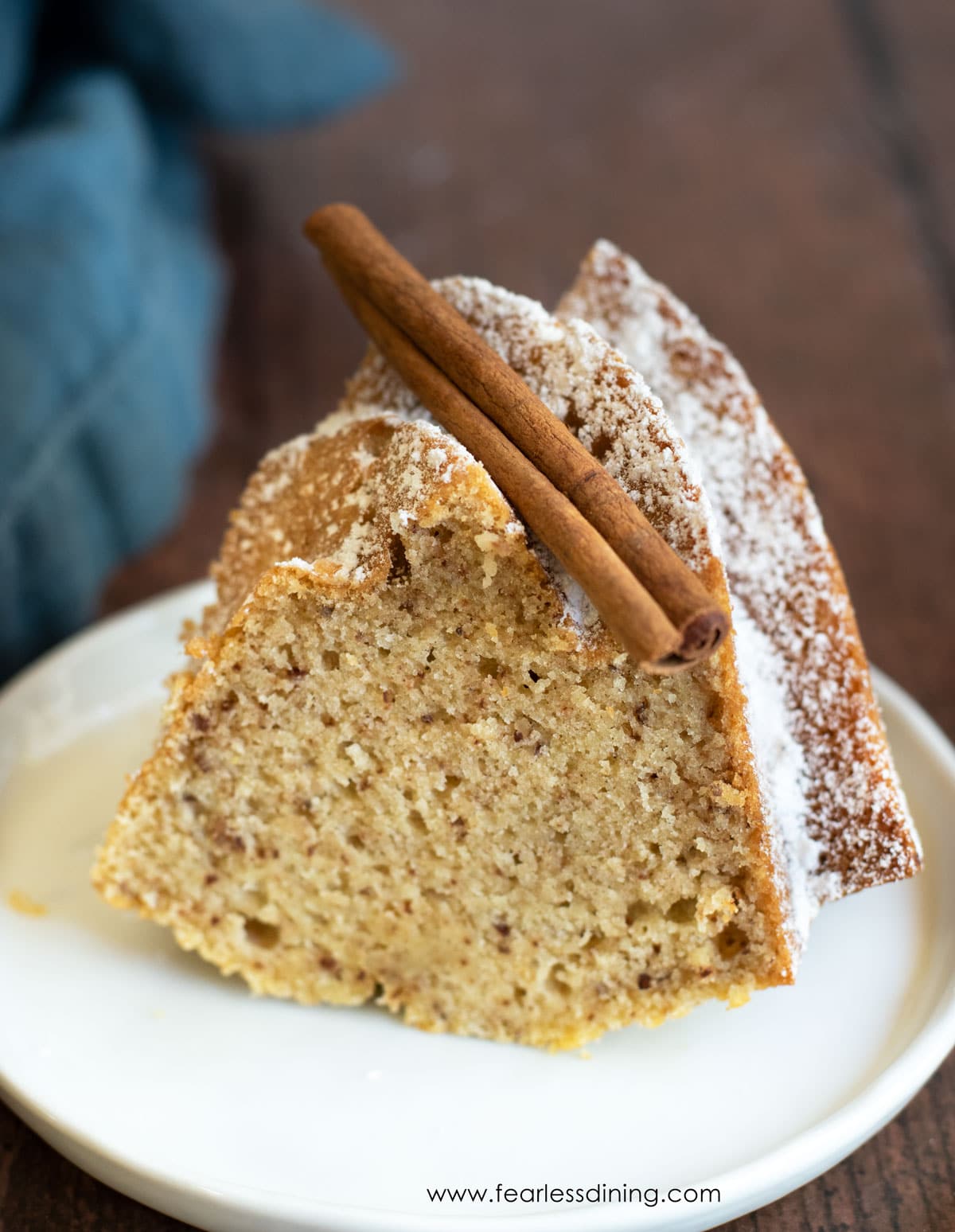 A slice of gluten free eggnog bundt cake on a white plate.