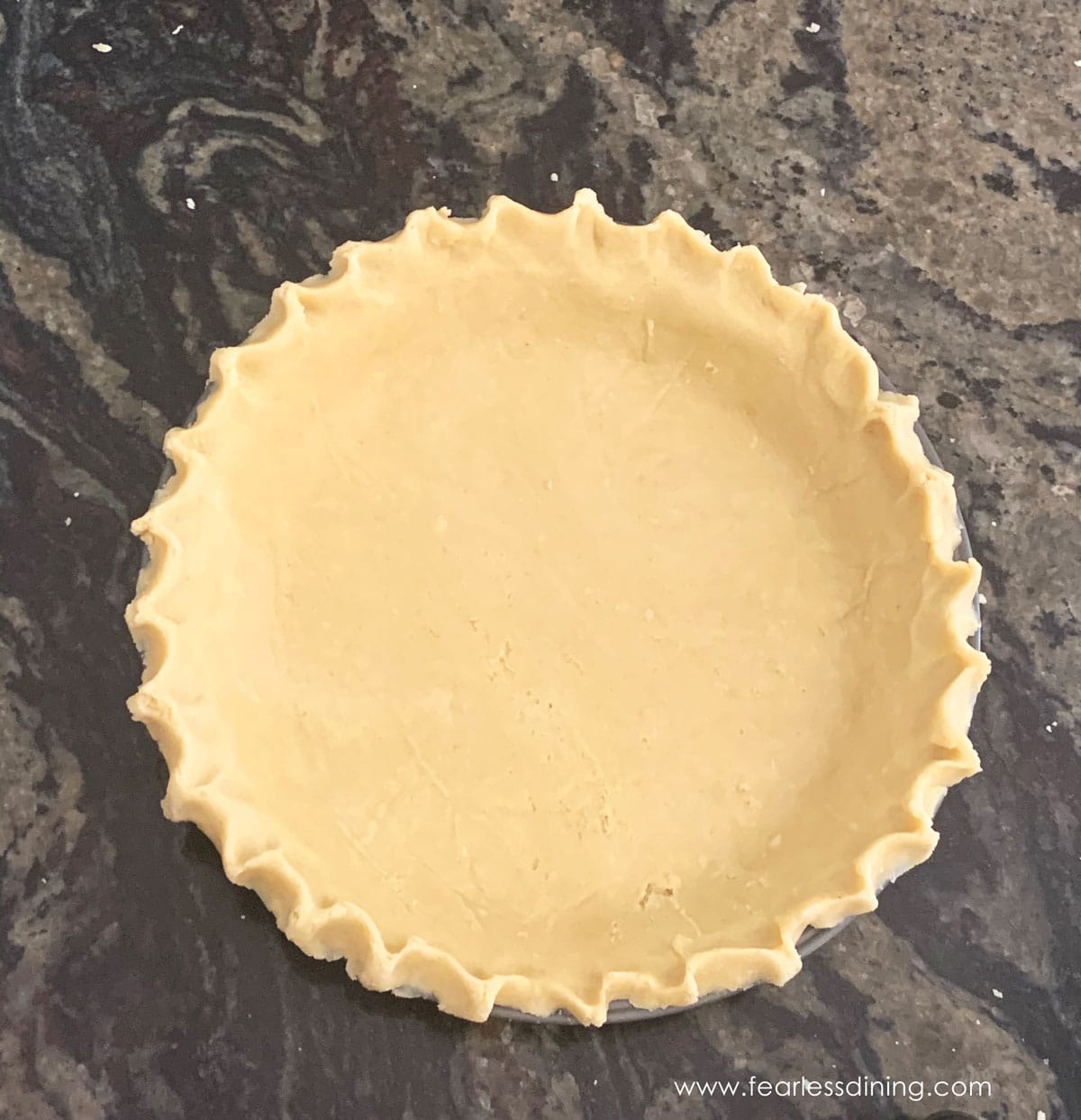 A pie crust ready to bake.