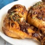 Barbecue slow cooker leg quarters on a platter.