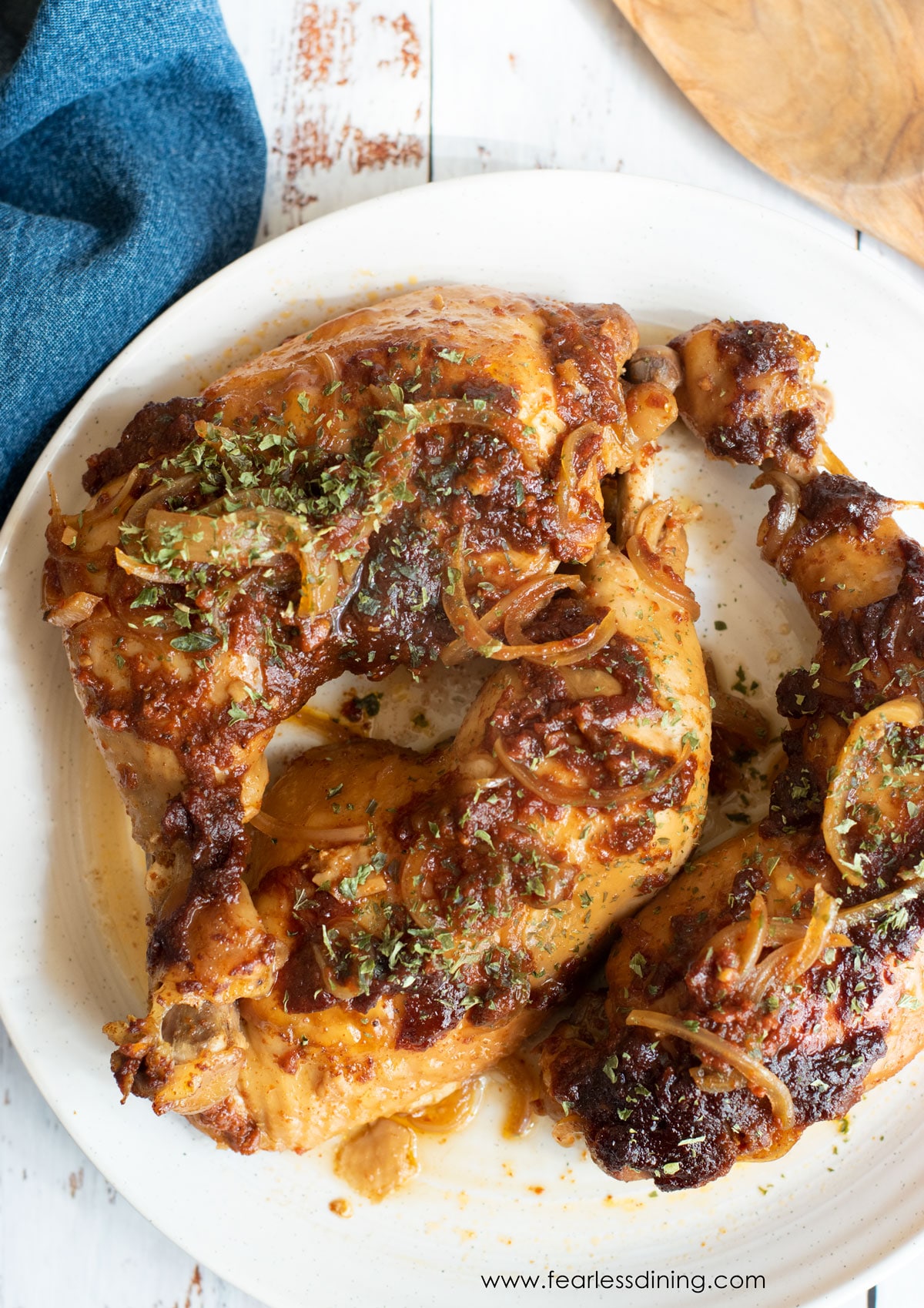 The top view of a platter with cooked chicken quarters.