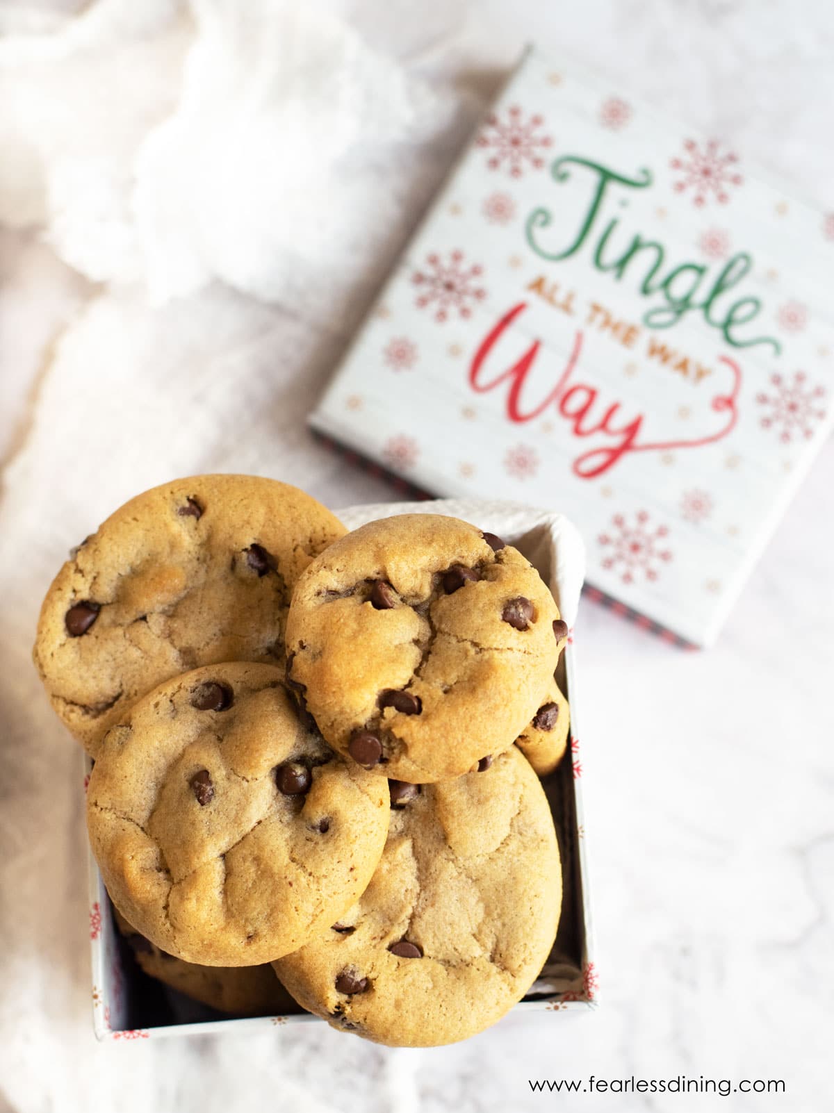 A holiday gift box filled with chocolate chip cookies.