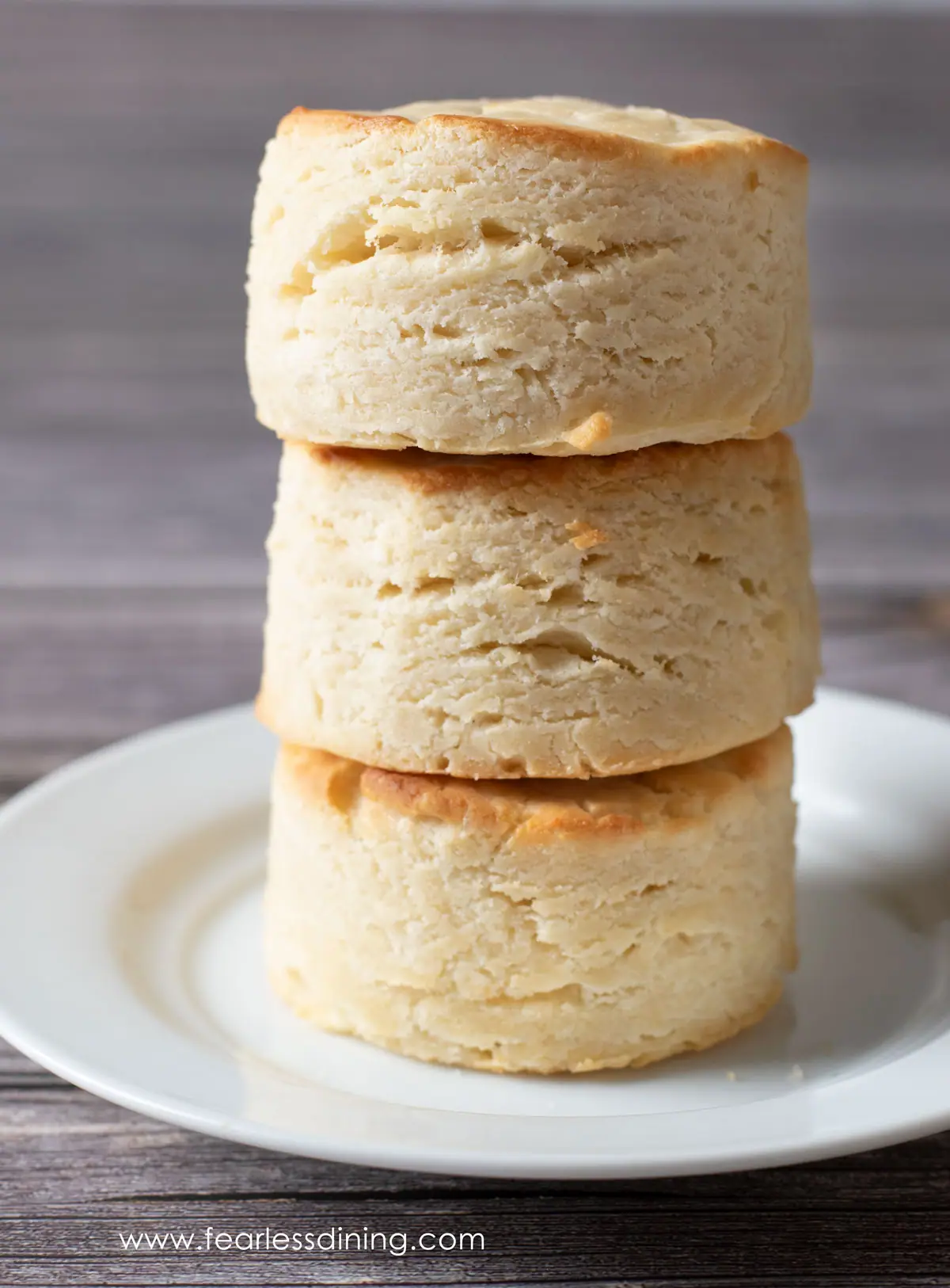 a stack of three biscuits on a plate