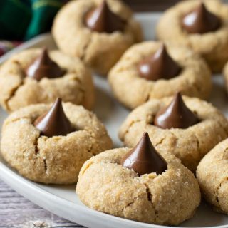 A plate full of gluten free peanut butter blossoms.
