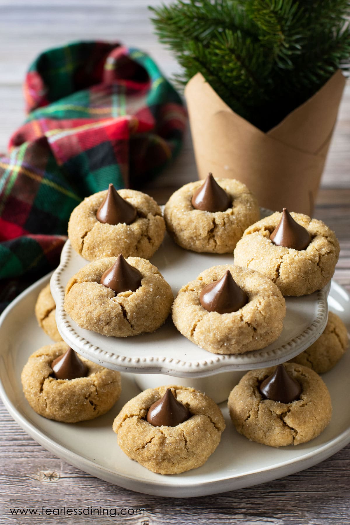 gluten free peanut butter blossoms on a tiered serving dish.