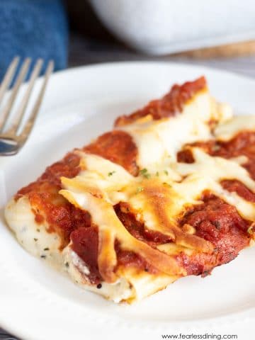 a plate with two cheese stuffed manicotti