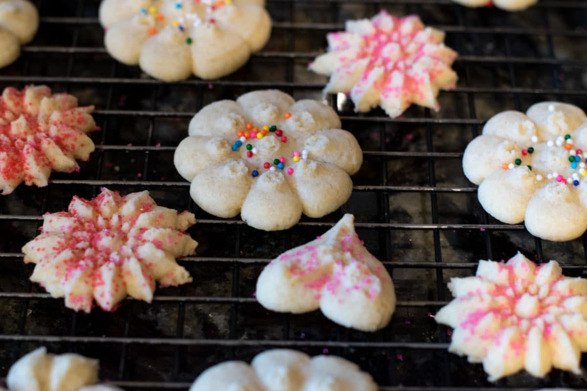A wire rack of decorated spritz cookies.