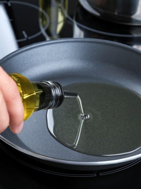 pouring oil into a skillet for frying