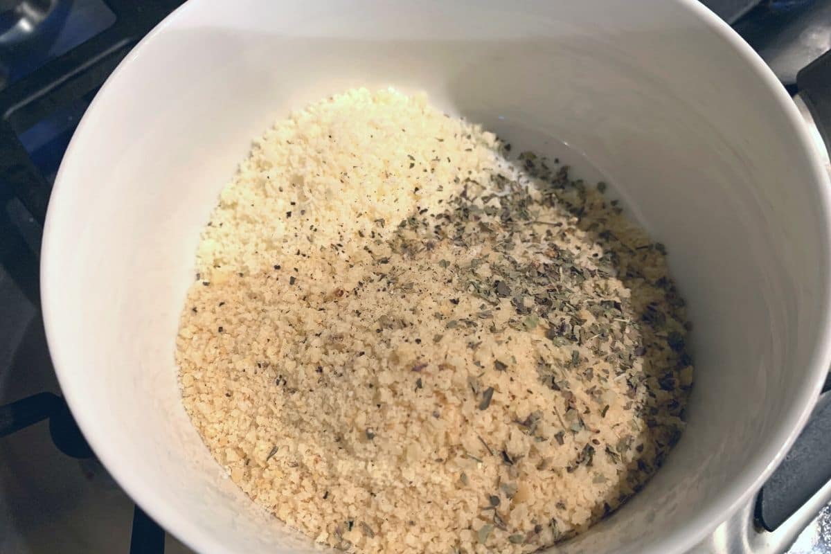 Gluten free panko, parmesan, and seasonings in a small bowl ready to mix.