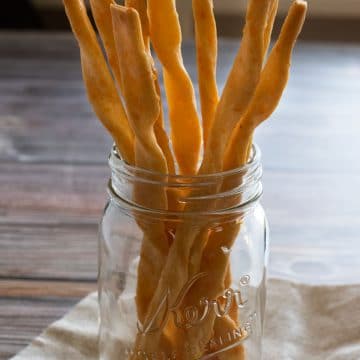 a jar filled with crispy gluten free cheese straws