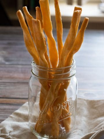 a jar filled with crispy gluten free cheese straws