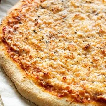 A gluten free pizza on a baking sheet.