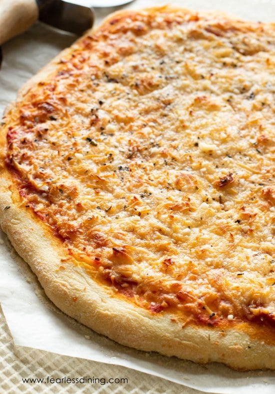 A gluten free pizza on a baking sheet.