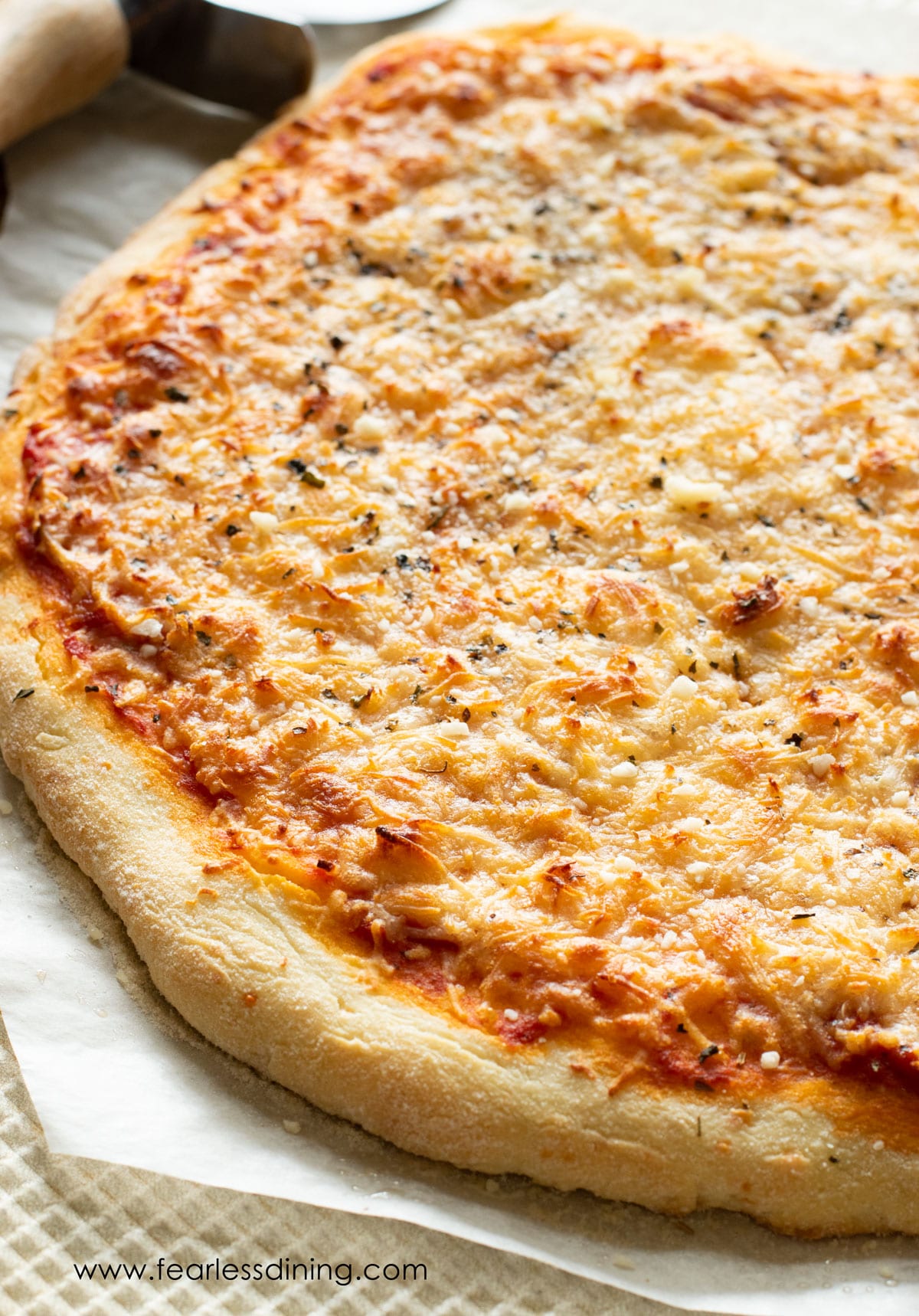 A gluten free pizza on a baking sheet