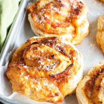 A baking sheet with baked gluten free pizza rolls