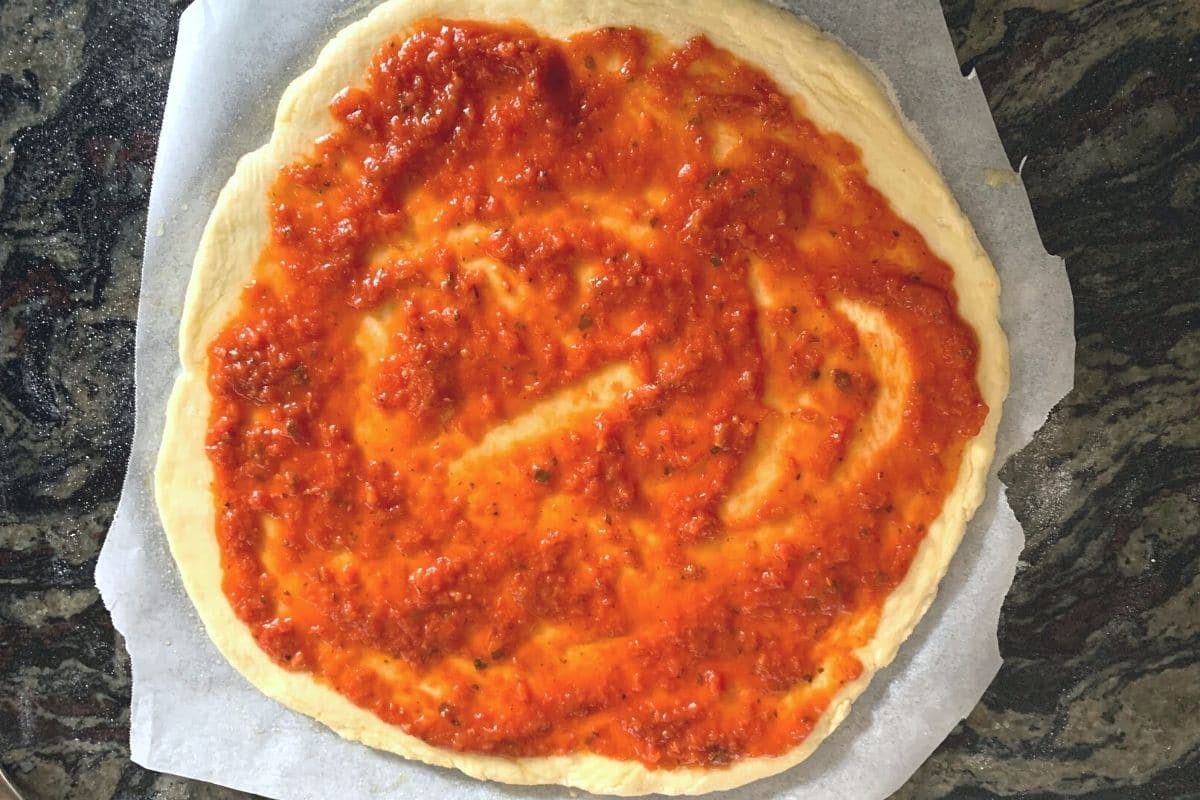 The sauce spread on pizza crust.