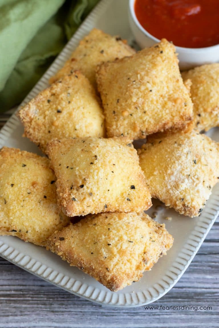 Ten air fried ravioli on a serving platter.