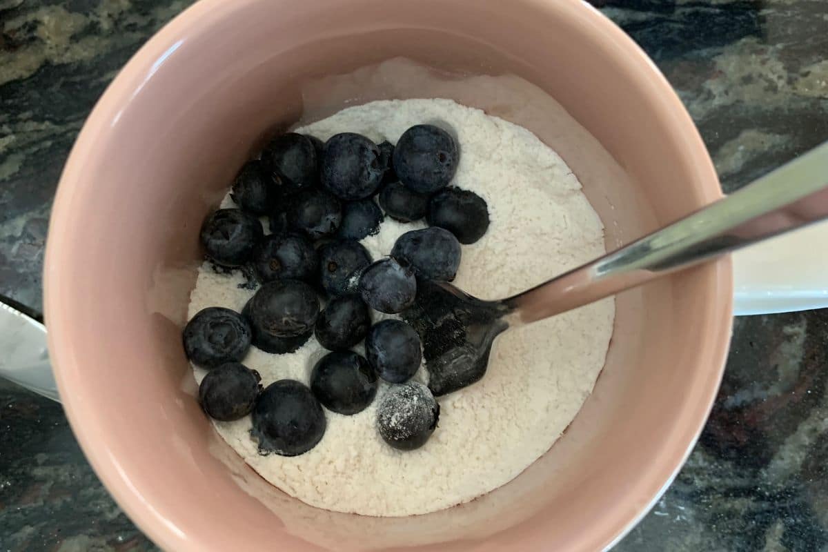 A mug with the dry muffin ingredients in it.