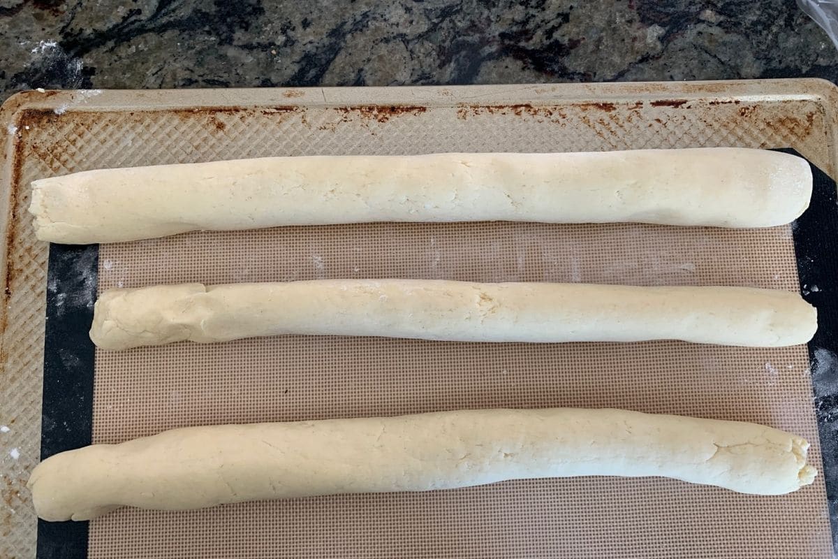 A photo showing three dough ropes ready to braid.