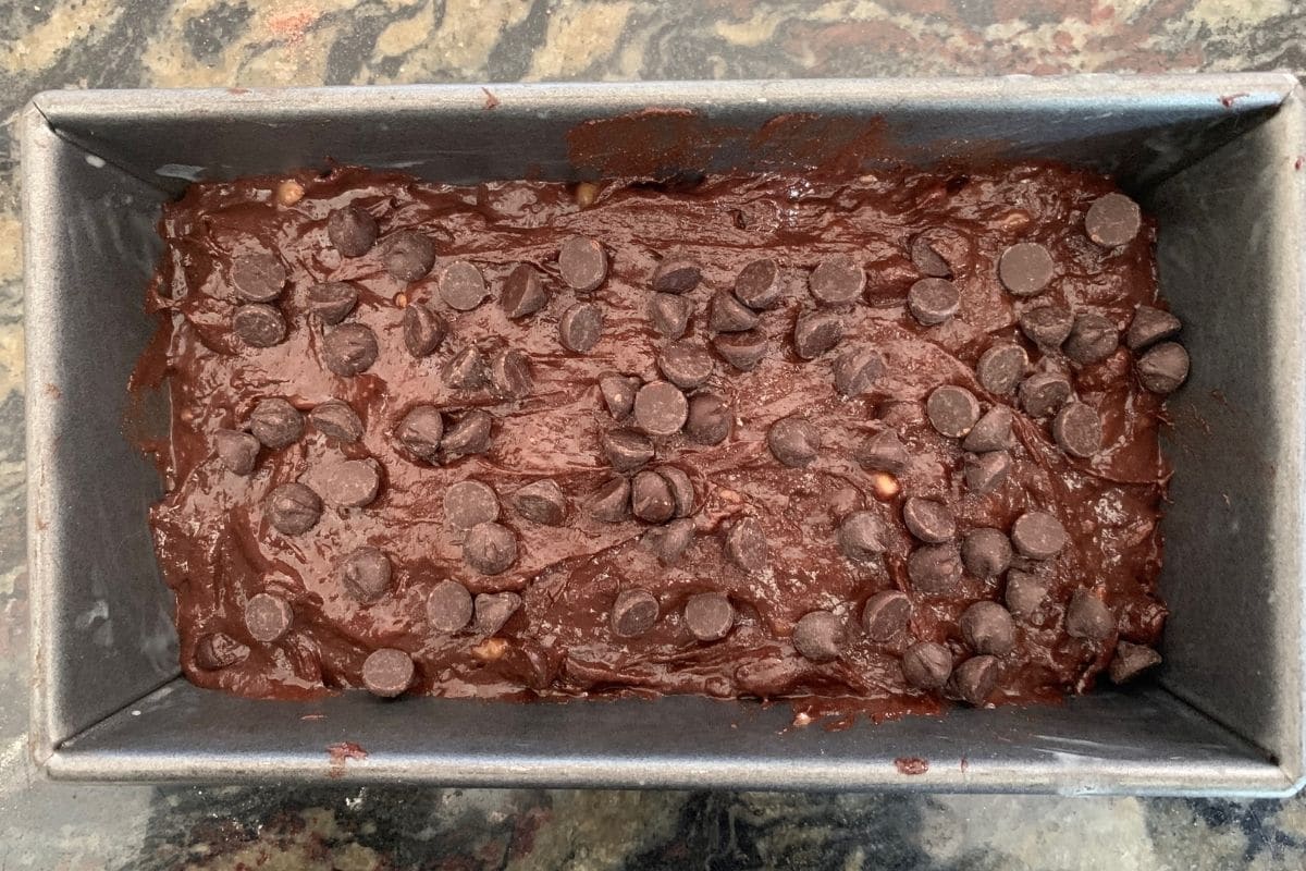 The chocolate banana bread batter in a loaf pan.