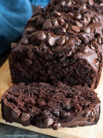 The front of a sliced loaf of chocolate banana bread.