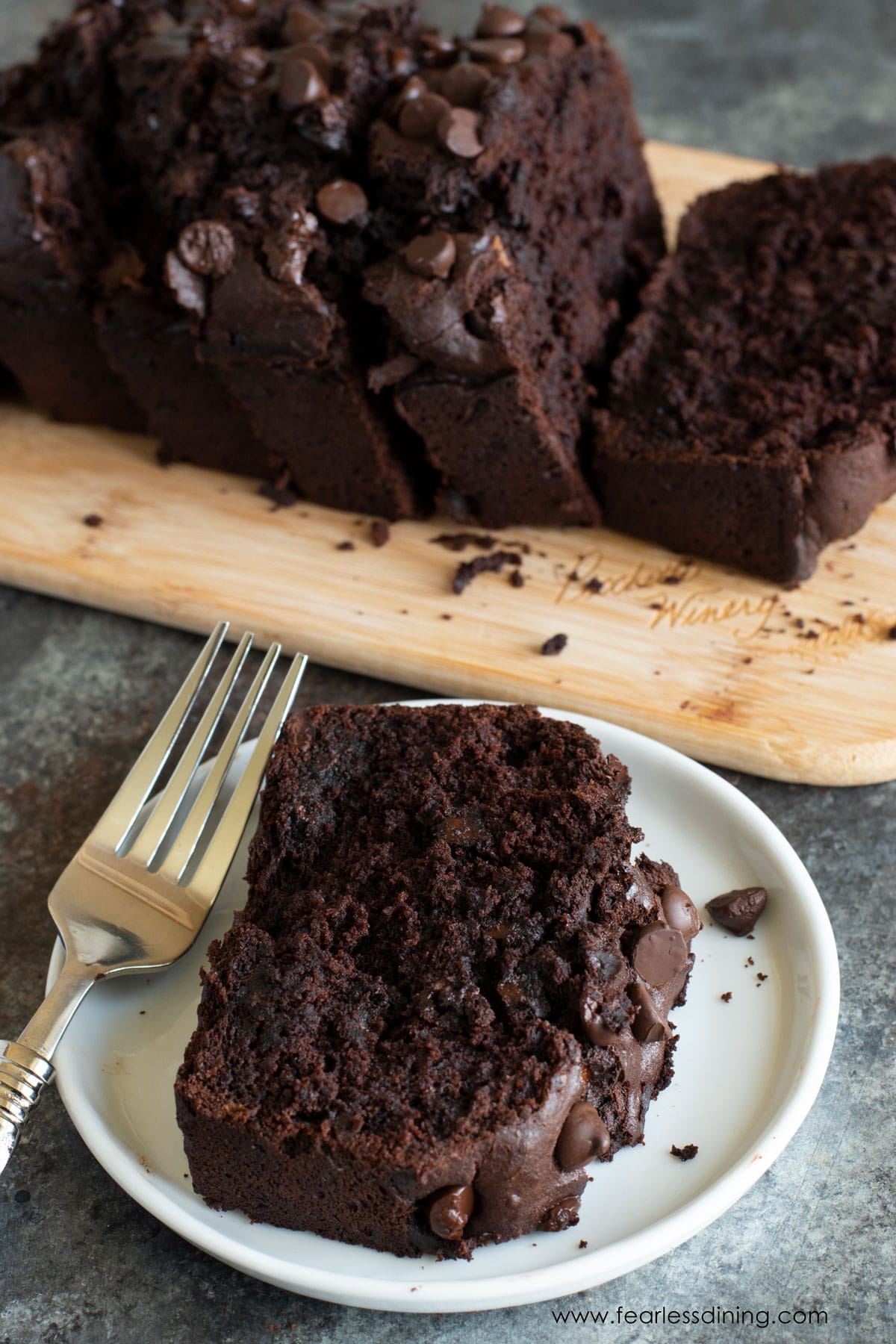 A slice of gluten free chocolate banana bread on a plate.