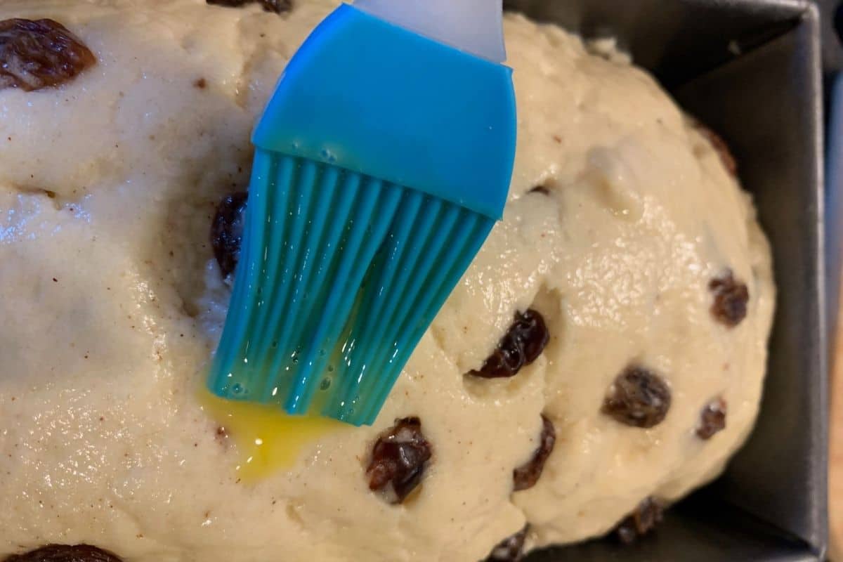 Brushing the egg wash over the dough.