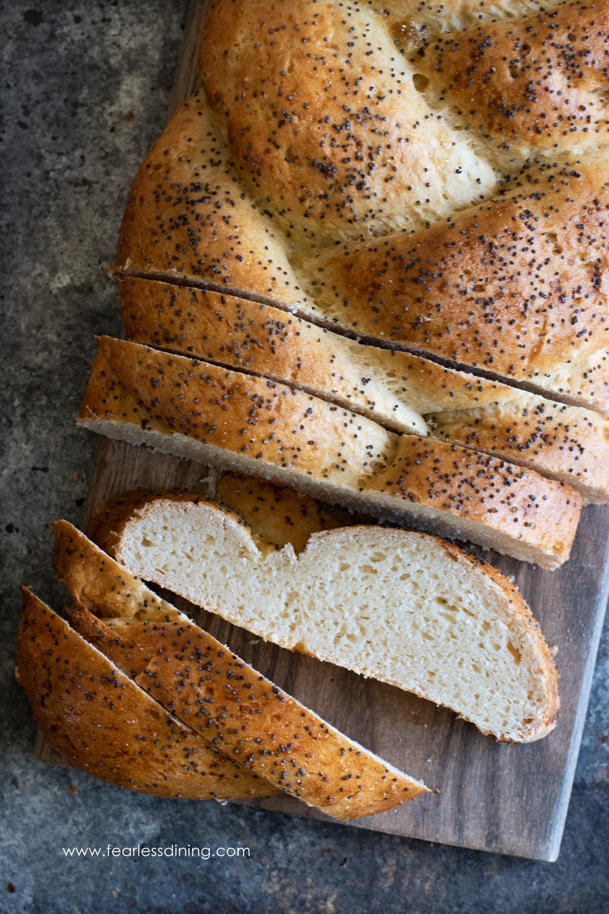 The top view of a sliced gluten free challah on a cutting board.