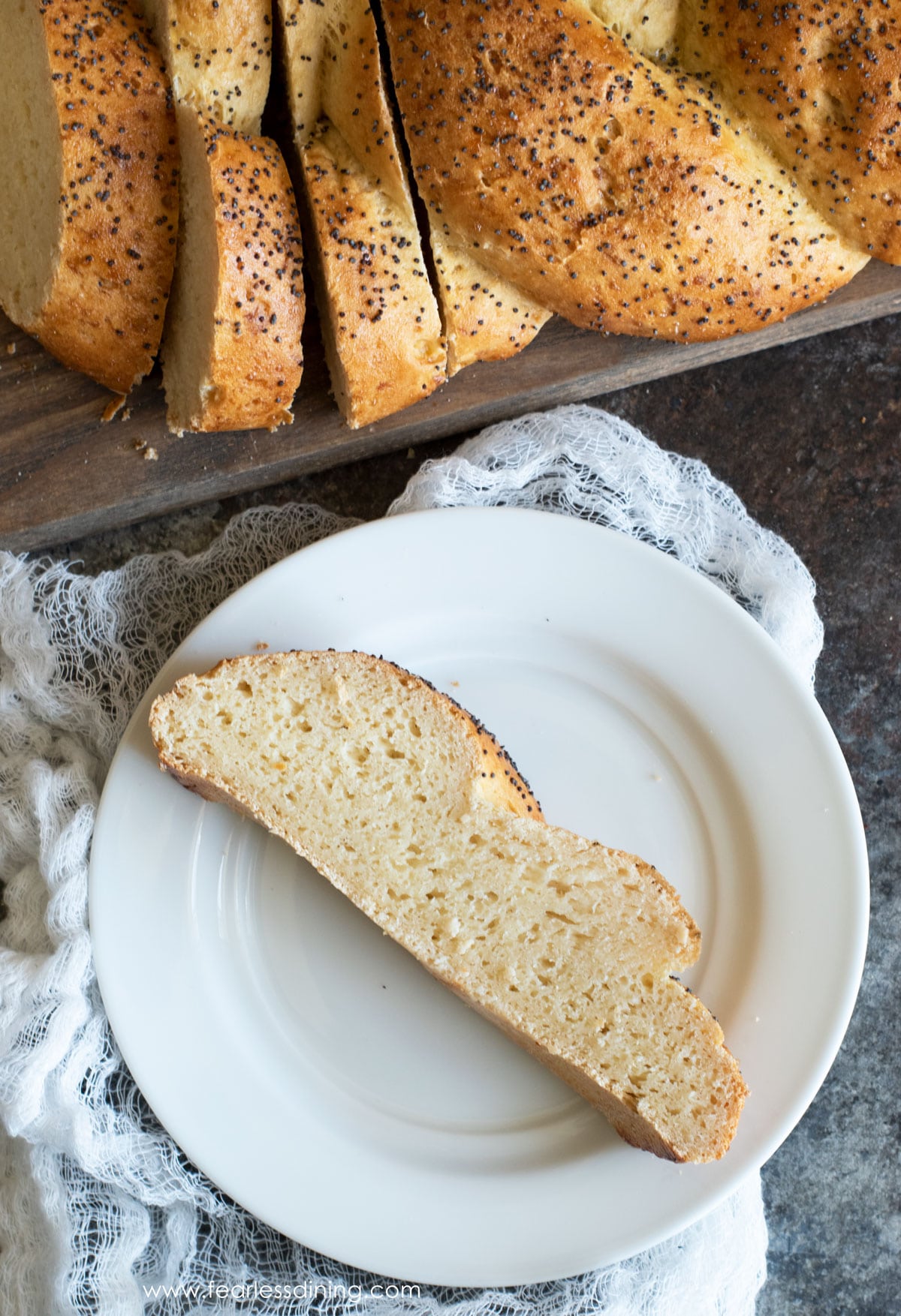 A slice of gluten free challah on a white plate.