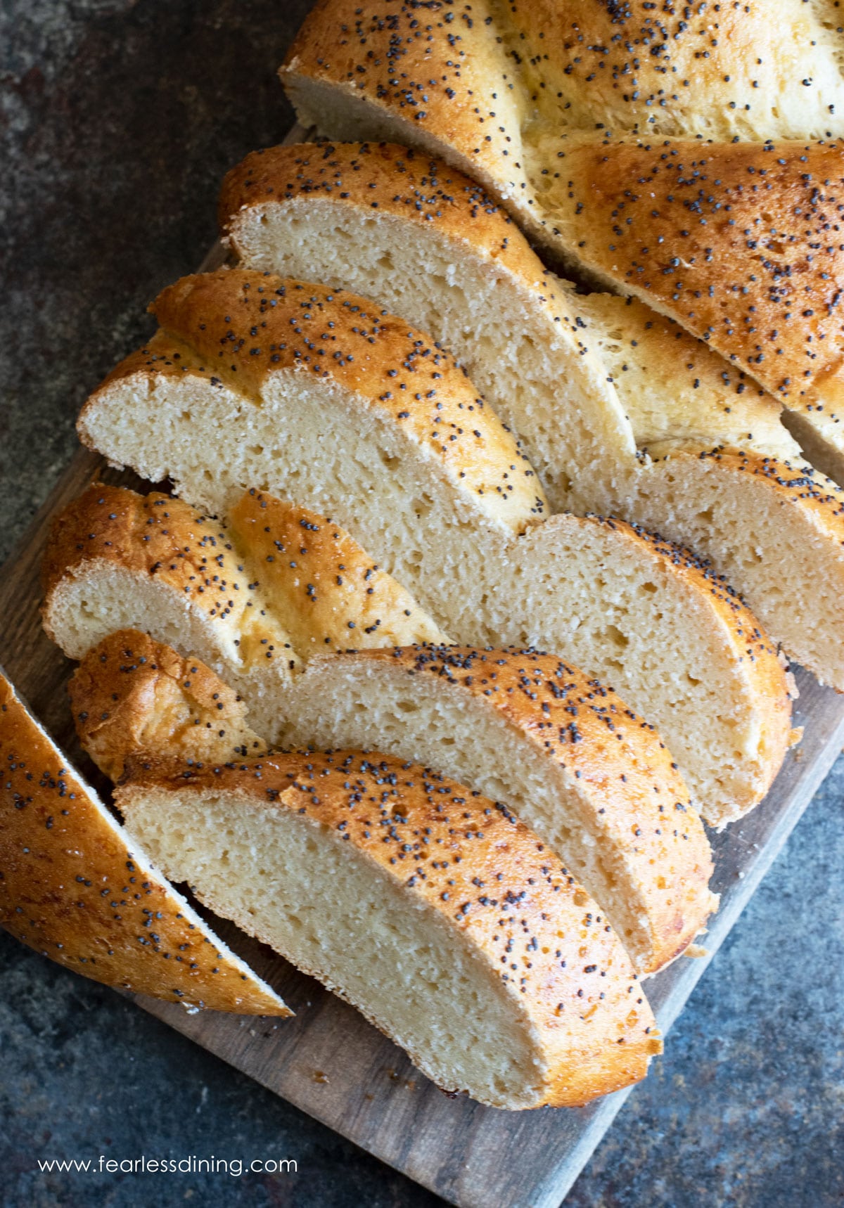 Slices of gluten free challah on a cutting board.