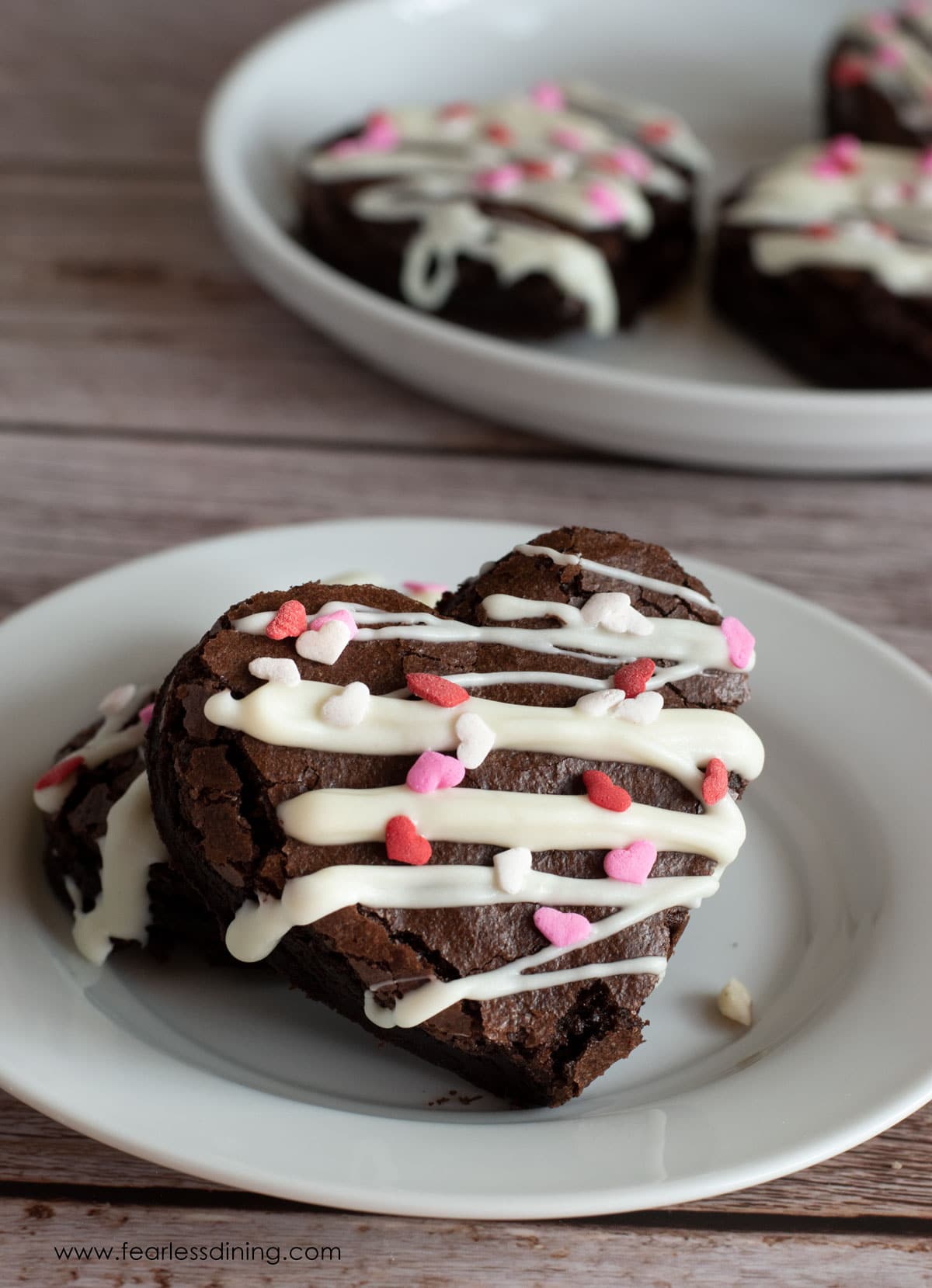 Gluten free heart-shaped brownies with heart sprinkles.