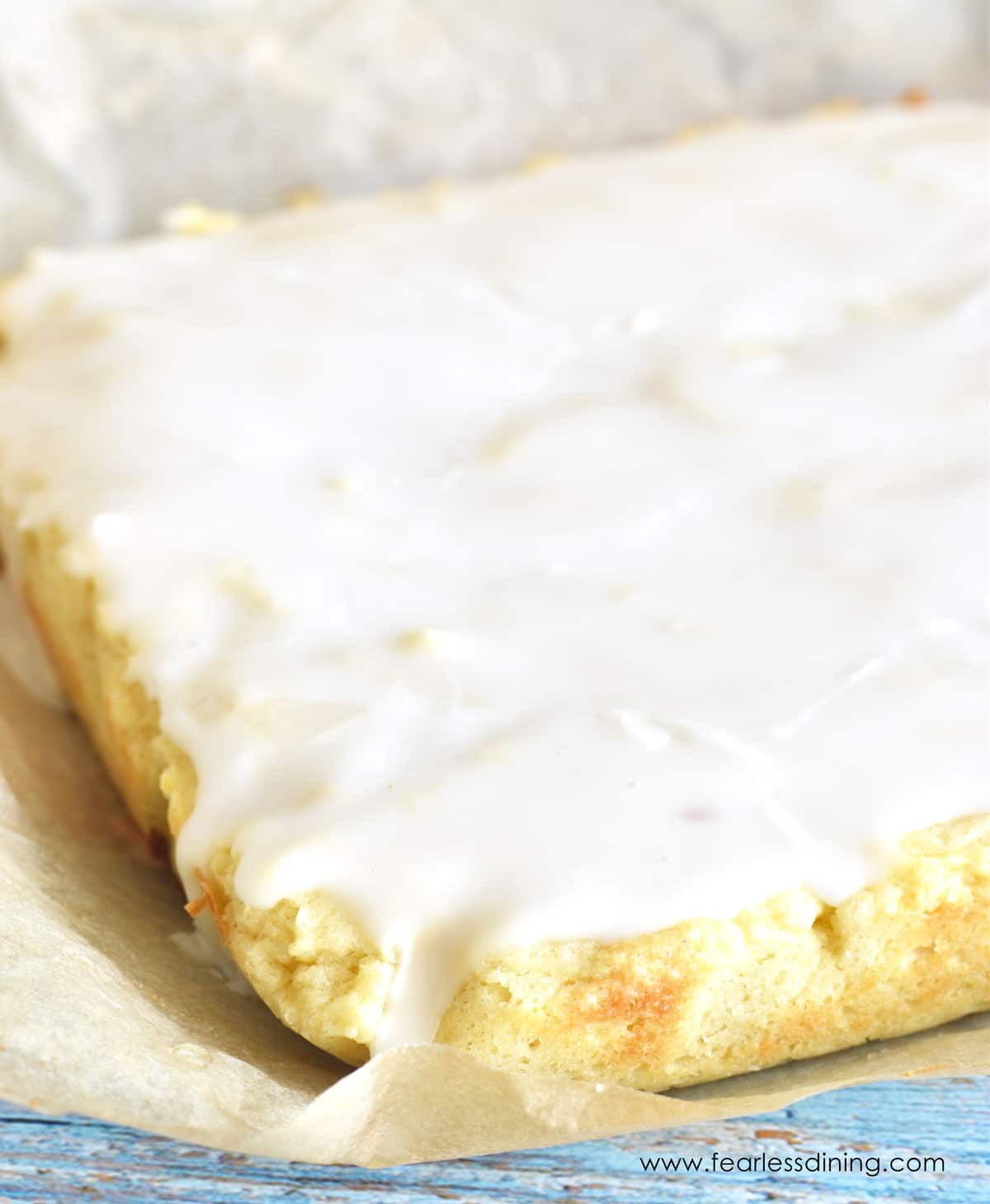 Glaze spread over the lemon brownies.