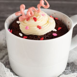 A gluten free red velvet mug cake in a white mug.
