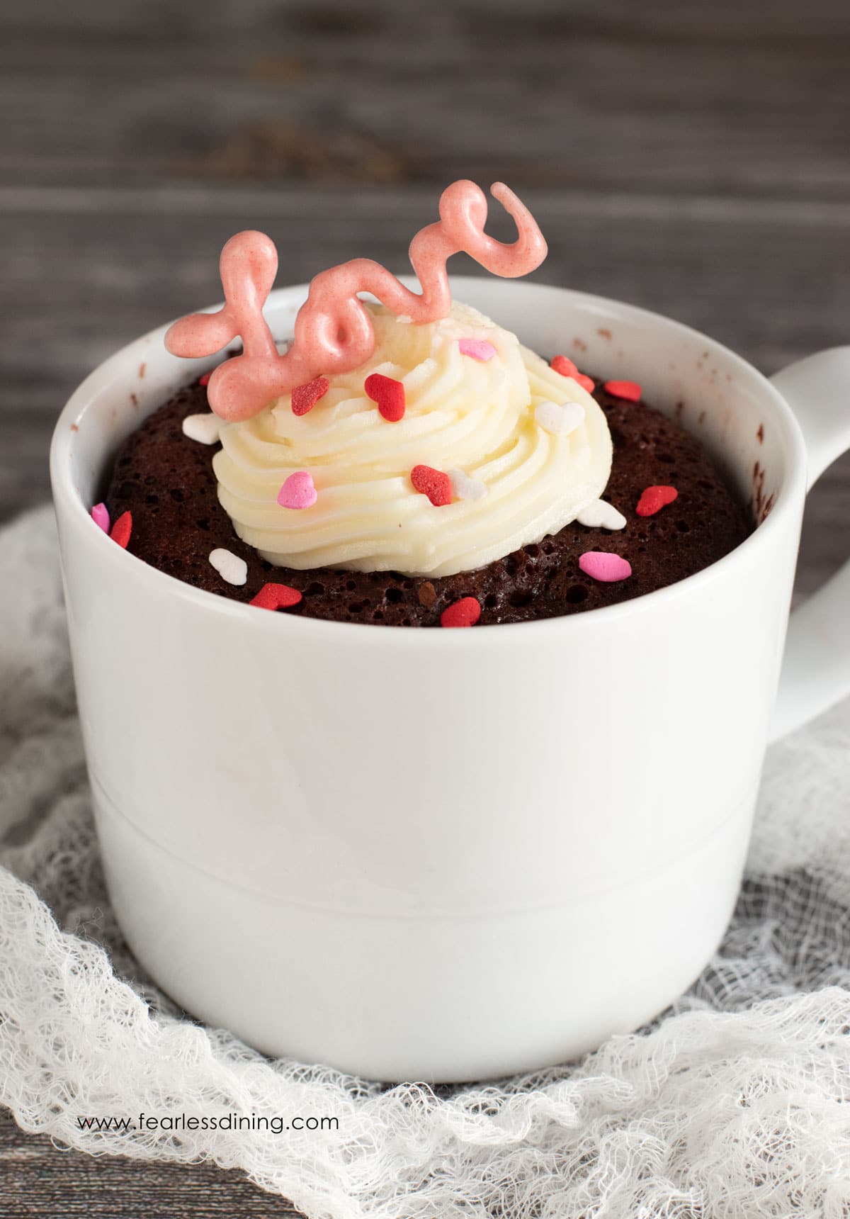 A gluten free red velvet mug cake in a white mug.
