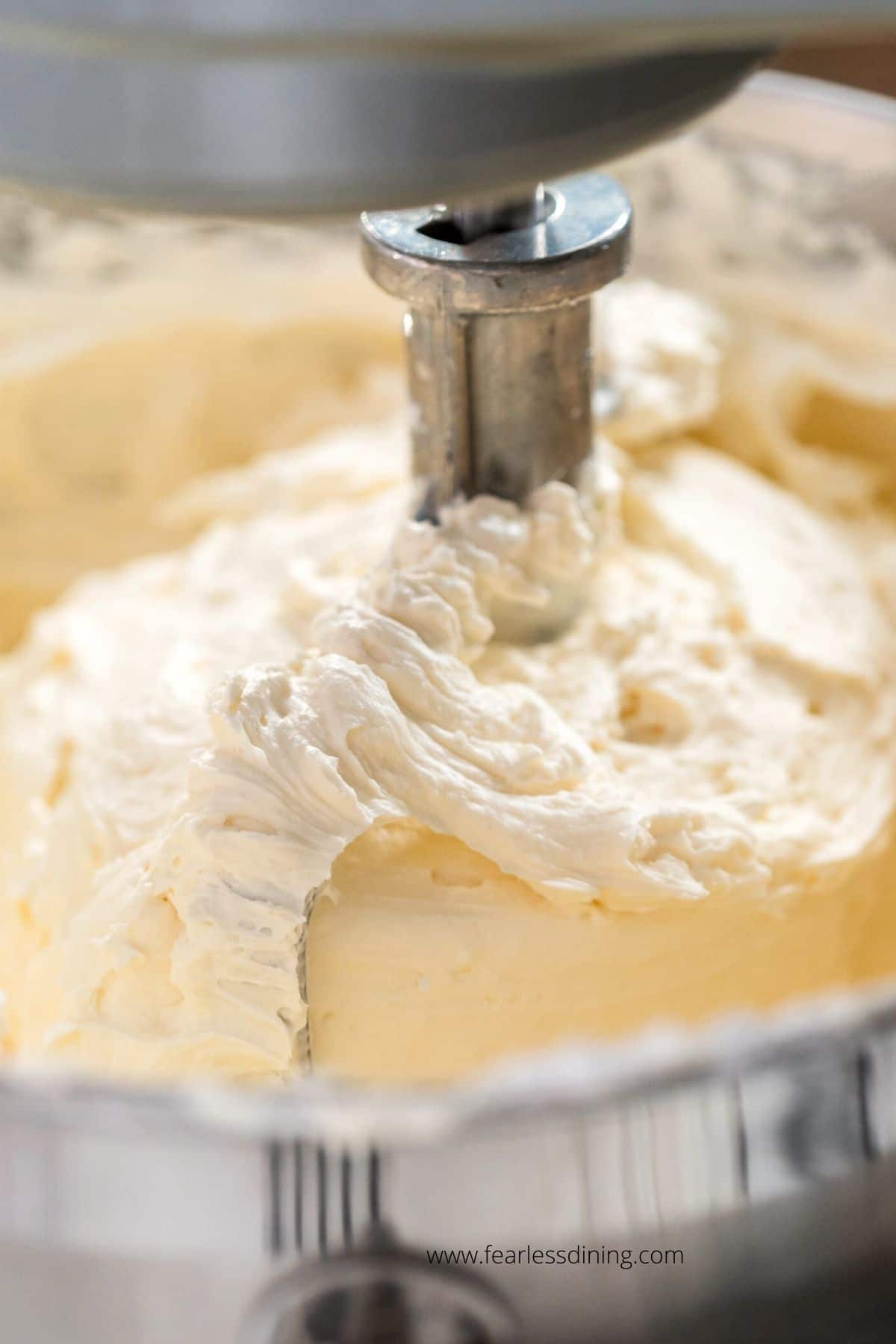 Vanilla buttercream frosting in a Kitchen Aid standing mixer.