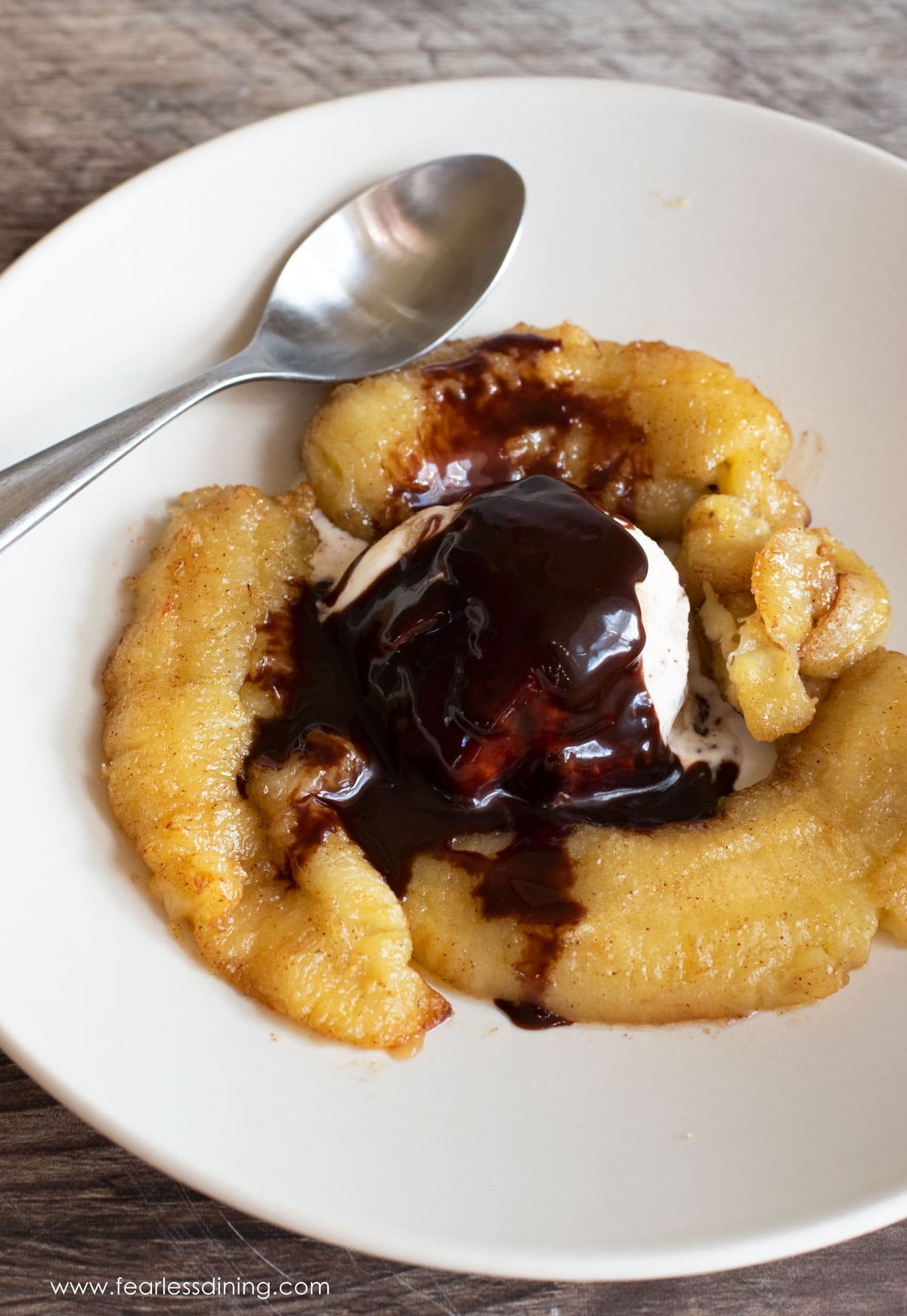 The top view of the caramelized bananas with ice cream and chocolate sauce.
