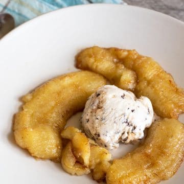 Caramelized air fryer banana with a scoop of ice cream.