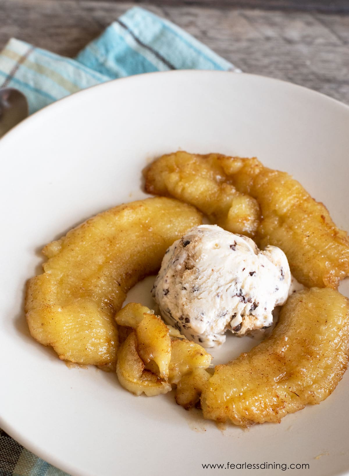 Caramelized air fryer banana with a scoop of ice cream.