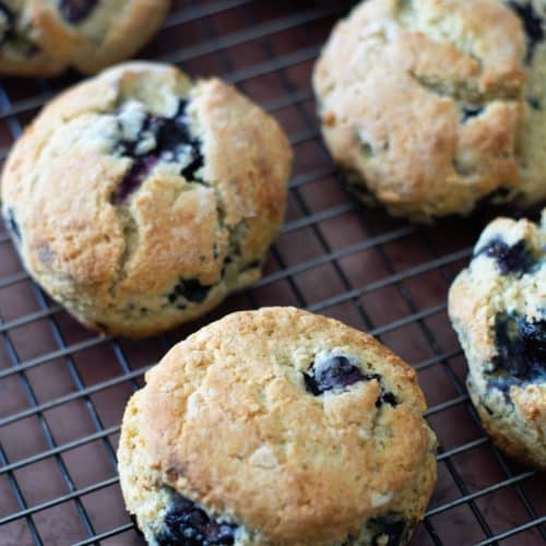 Gluten-free blueberry scones on a cooling rack.
