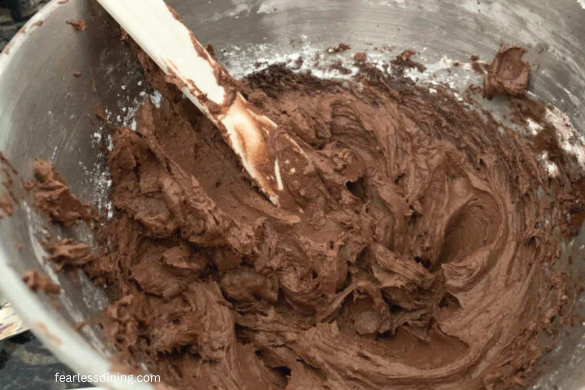 Chocolate frosting in a mixing bowl.