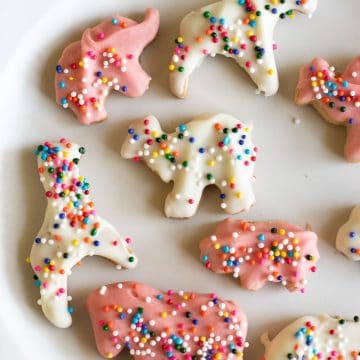 Gluten free pink and white circus cookies on a plate.