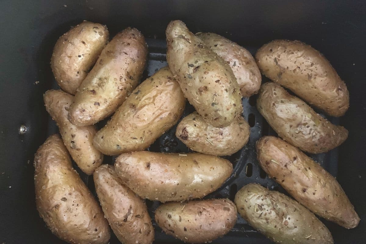 roasted fingerling potatoes in the air fryer basket.