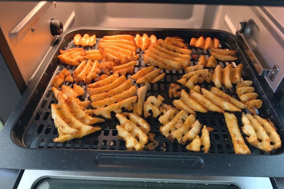 air fried waffle fries on a rack.