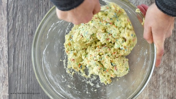 mixing funfetti cookie dough in a bowl.