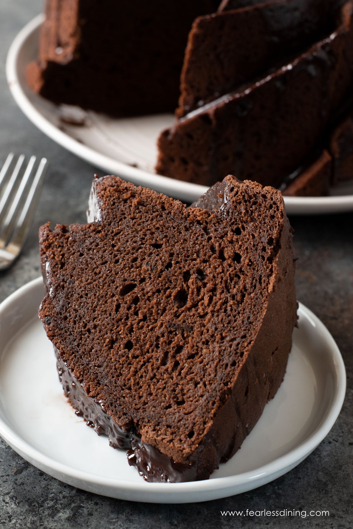 A close up of a slice of the chocolate cake on a plate.